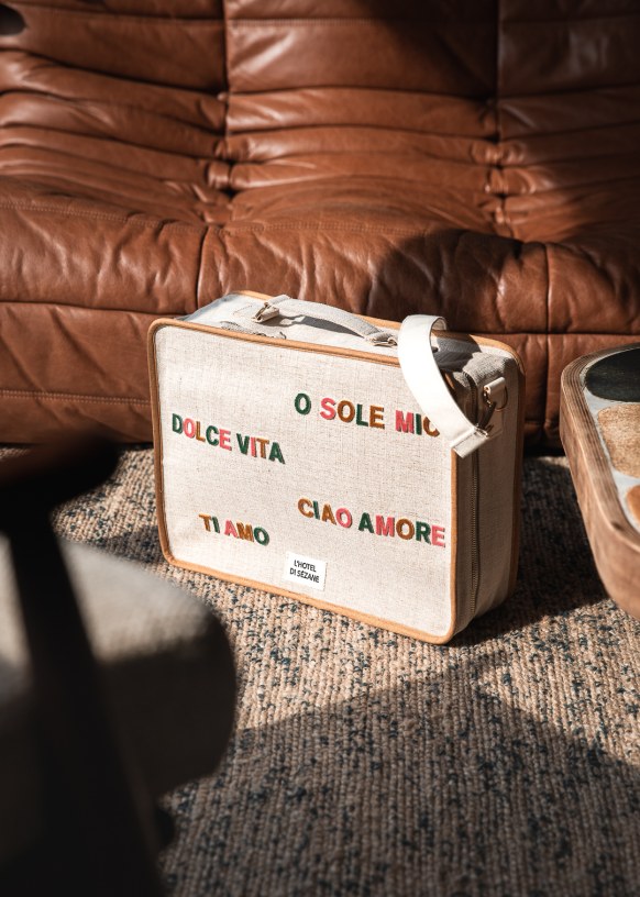 Embroidered small suitcase Italian words White Sézane