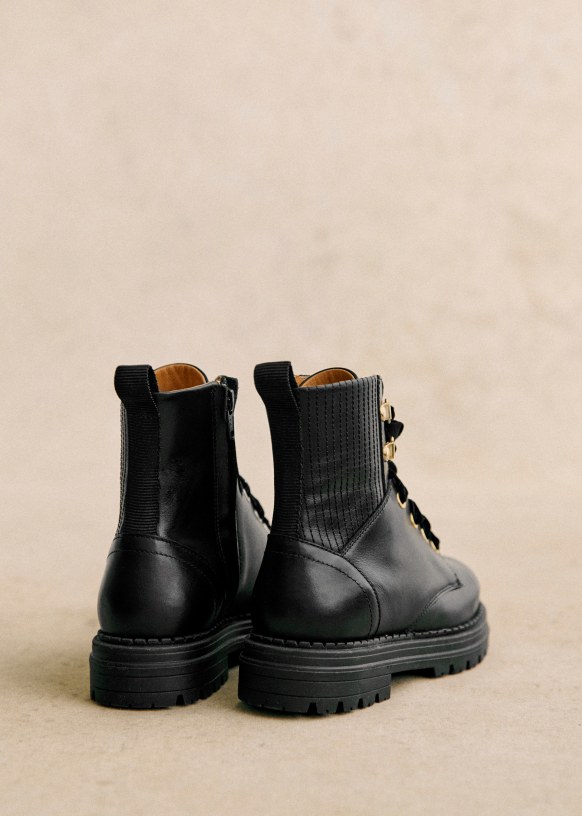 Black boots with gold hardware top